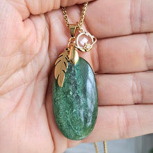 Charger l'image dans la galerie, Collier aventurine longue ovale naturelle chaine acier dor et breloques plume et étoile dans la main