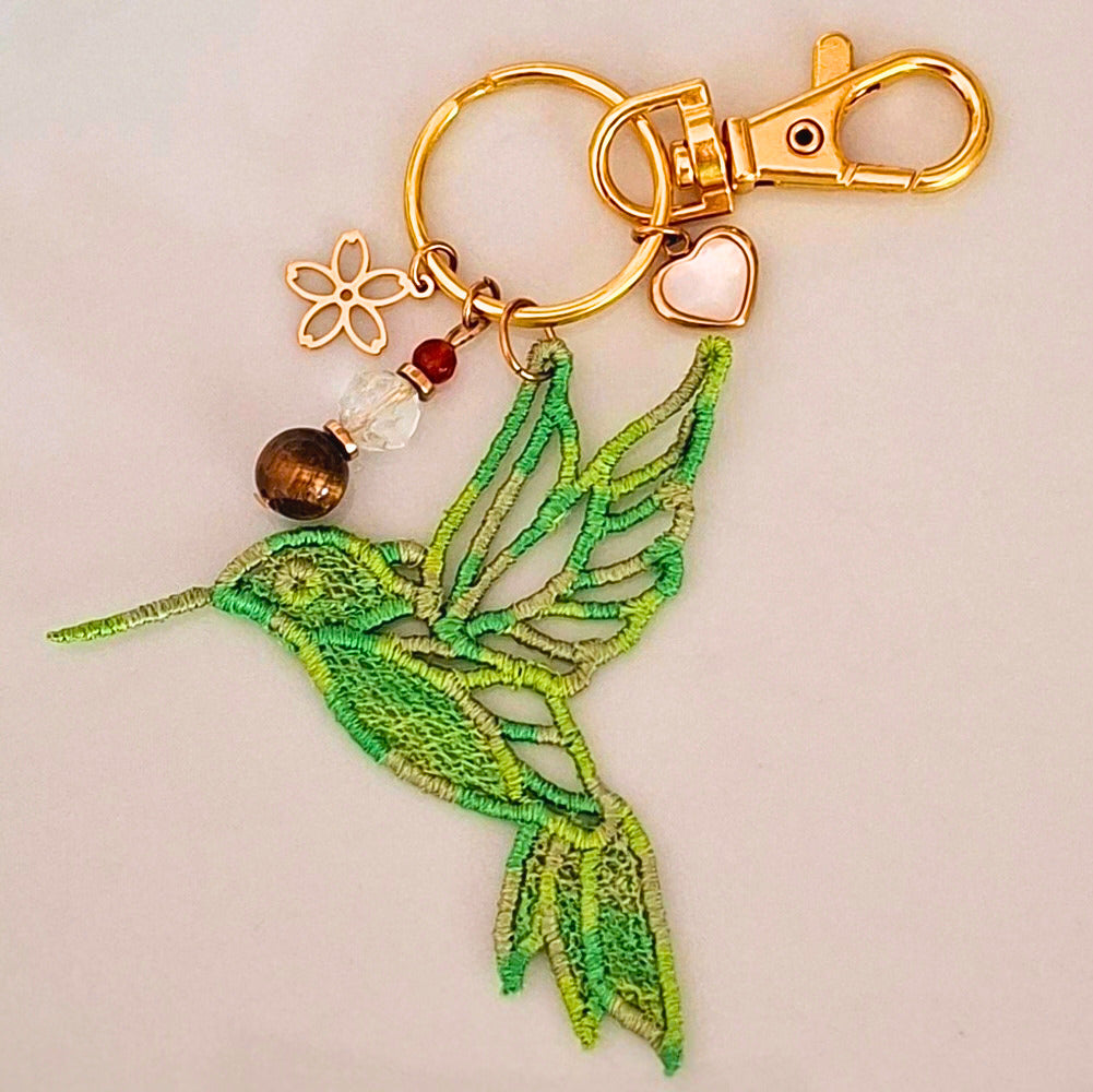 Bijou de sac Colibri Joie de vivre vert brodé avec œil de tigre, citrine et cornaline